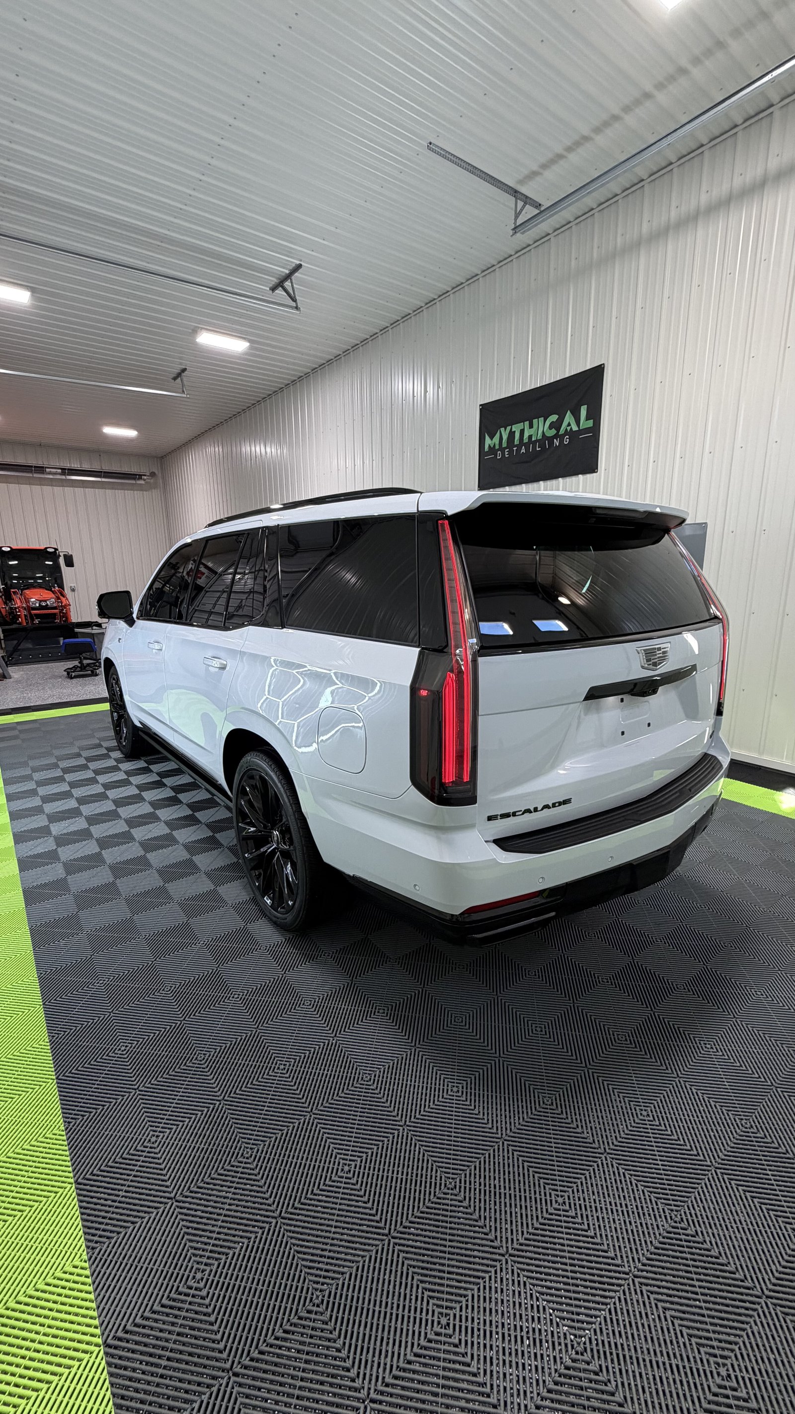 White Cadillac Escalade IQ finished with ceramic coating inside the Mythical Detailing shop