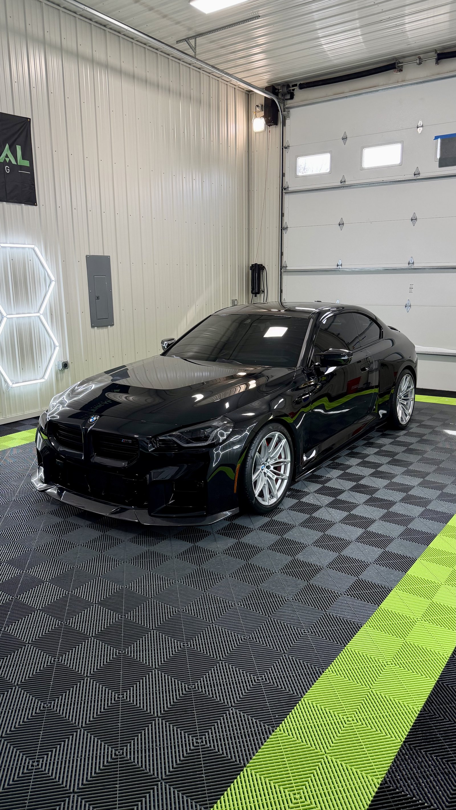 Glossy black BMW M2 finished with ceramic coating in a Kansas City detail shop