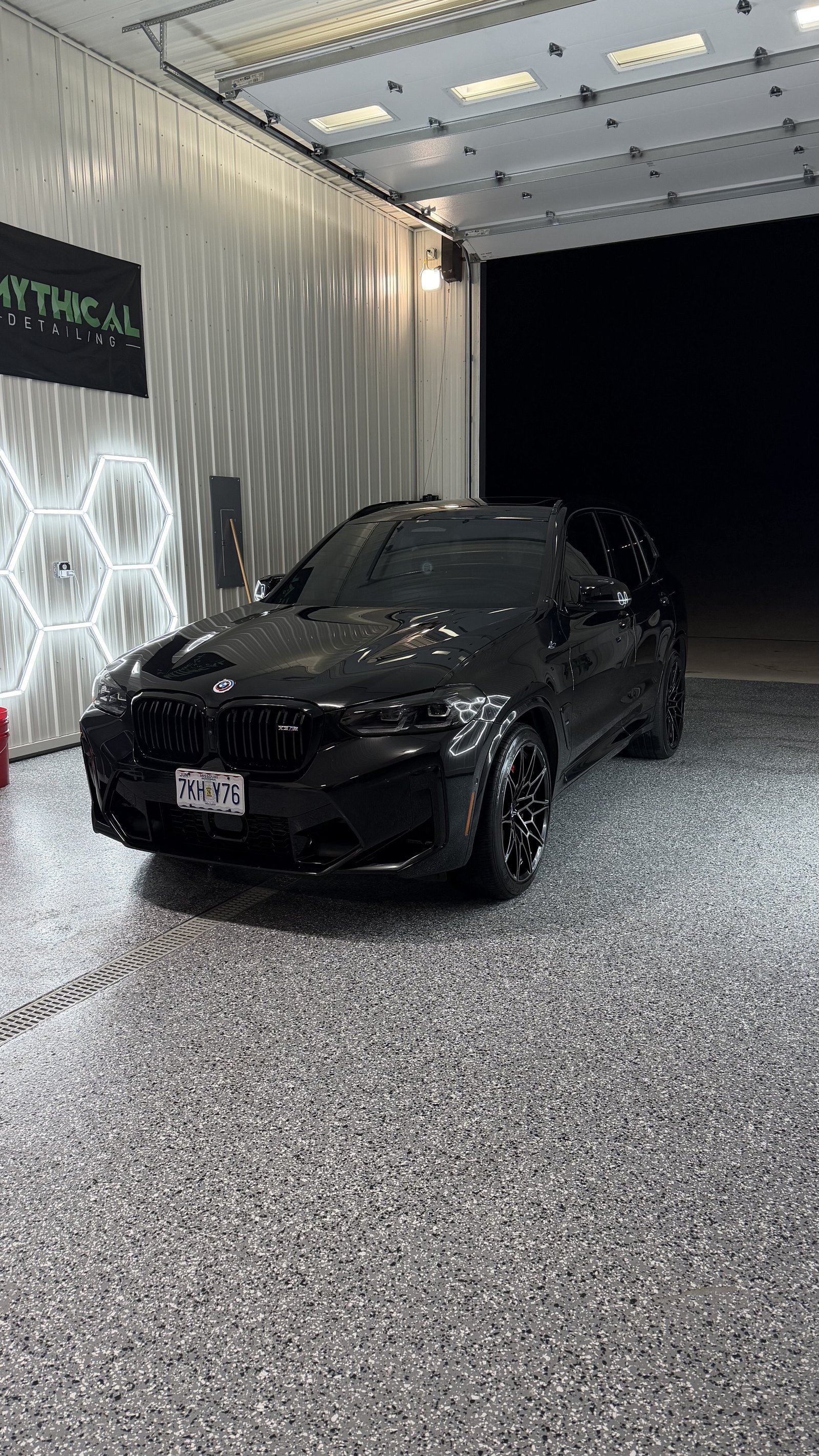 Glossy black BMW X3M finished with paint correction in a Kansas City detail shop